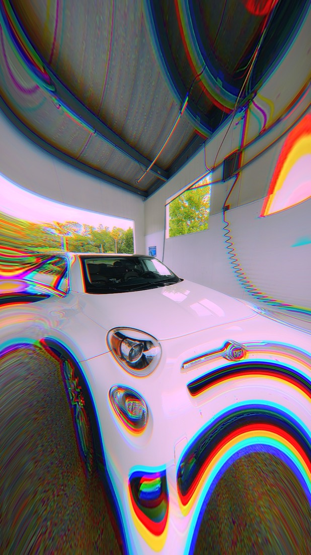 Photo shot with Liquid Lens: chromatic aberration and warp on a car wash bay
