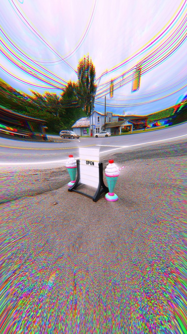Photo shot with Liquid Lens: roadside ice cream sign with a glitch color effect